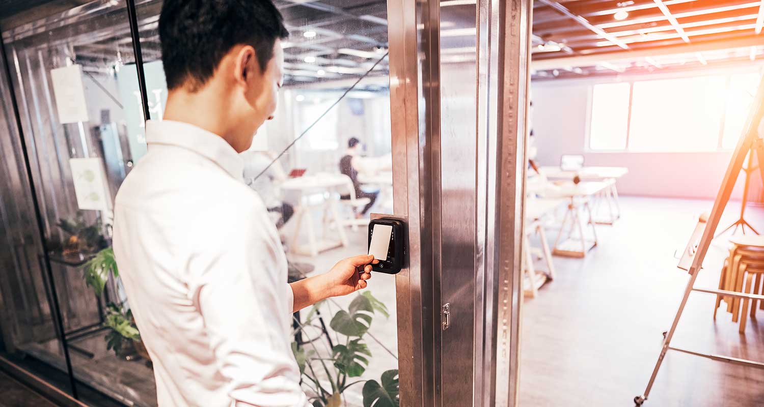 A worker using a security system to access a room