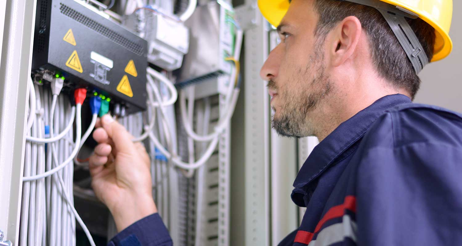 A field technician working on a fiber connection