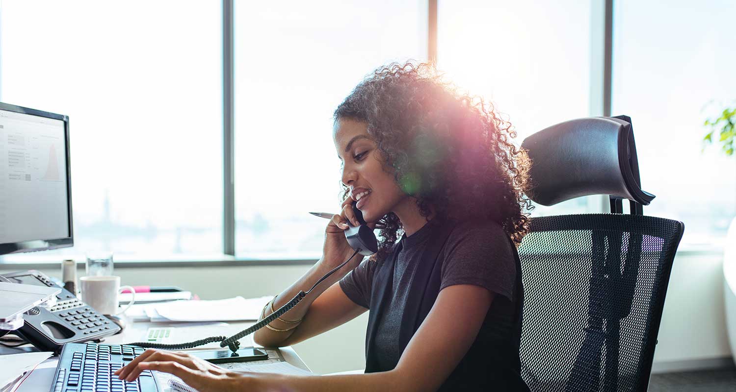 An office worker using a Voice Over IP system